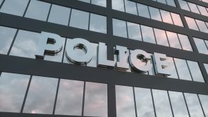 Police,Sign,On,A,Modern,Glass,Skyscraper.,Police,Glass,Building.